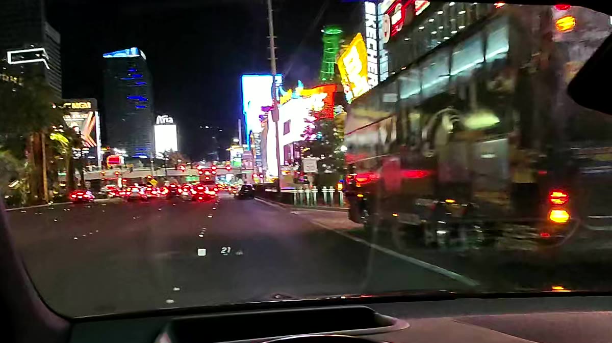 Driving down the Las Vegas Strip at night from the driver's seat